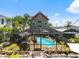 Backyard view of the green home featuring a screened-in pool and patio area, perfect for entertaining at 2504 W North A St # A, Tampa, FL 33609