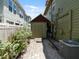 A backyard shed surrounded by small landscaped shrubbery and neighboring homes at 2504 W North A St # A, Tampa, FL 33609