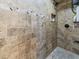 Tiled shower with pebble flooring, built-in niche, and dark fixtures at 2504 W North A St # A, Tampa, FL 33609