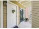 Charming front entrance with decorative flower basket and covered patio at 302 Lake Parsons Grn # 104, Brandon, FL 33511