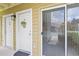 Welcoming entryway features a decorative wreath on the front door and a screened sliding door, bringing the outdoors in at 302 Lake Parsons Grn # 104, Brandon, FL 33511