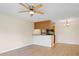 Open-concept living and dining space with modern flooring, flowing seamlessly into a well-equipped kitchen at 302 Lake Parsons Grn # 104, Brandon, FL 33511