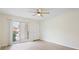 Bright, airy living room with light-colored floors and sliding door access to a private patio, perfect for relaxation at 302 Lake Parsons Grn # 104, Brandon, FL 33511