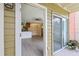 Inviting open-concept living area with modern floors, seamlessly connecting to the kitchen and outdoor patio at 302 Lake Parsons Grn # 104, Brandon, FL 33511