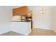 Bright living space connecting kitchen and dining areas, featuring modern floors and a functional breakfast bar at 302 Lake Parsons Grn # 104, Brandon, FL 33511
