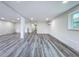 Finished basement featuring gray wood floors, white walls, and recessed lighting at 309 Congress St, Oldsmar, FL 34677