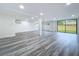 Finished basement featuring gray wood floors, recessed lighting, and a sliding glass door to the exterior at 309 Congress St, Oldsmar, FL 34677