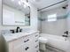Bathroom featuring white vanity, quartz countertop, black fixtures, and tiled tub-shower combo at 309 Congress St, Oldsmar, FL 34677