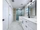 Bathroom featuring white cabinets, quartz countertop, black fixtures, and glass-enclosed shower at 309 Congress St, Oldsmar, FL 34677