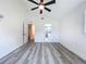 Bright bedroom featuring two doorways to a hallway and bathroom plus a modern ceiling fan at 309 Congress St, Oldsmar, FL 34677