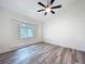 Cozy bedroom with a window seat, gray floors, and a modern ceiling fan at 309 Congress St, Oldsmar, FL 34677