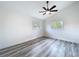 Bright bedroom featuring vaulted ceilings, gray wood-look floors, and a modern ceiling fan at 309 Congress St, Oldsmar, FL 34677
