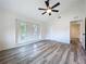 Bright bedroom featuring two windows, an adjacent closet, and gray wood-look floors at 309 Congress St, Oldsmar, FL 34677