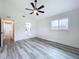 Bright bedroom features an ensuite bathroom, gray floors, and modern ceiling fan at 309 Congress St, Oldsmar, FL 34677