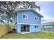 Charming blue two-story home with well-maintained lawn and fenced yard at 309 Congress St, Oldsmar, FL 34677