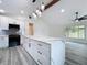 Bright kitchen with a large center island, pendant lighting, and views to the adjacent living area at 309 Congress St, Oldsmar, FL 34677