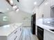 Modern kitchen featuring an oversized center island with stone countertops and pendant lighting at 309 Congress St, Oldsmar, FL 34677