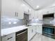 Beautiful kitchen featuring white cabinets, stainless steel appliances and stone countertops at 309 Congress St, Oldsmar, FL 34677