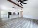 Open living space with wood-look floors and kitchen views with a vaulted ceiling at 309 Congress St, Oldsmar, FL 34677