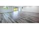 Spacious recreation room featuring modern gray wood-look flooring and ample natural light at 309 Congress St, Oldsmar, FL 34677