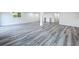 Spacious recreation room featuring modern gray wood-look flooring and ample natural light at 309 Congress St, Oldsmar, FL 34677