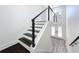 Interior view of modern staircase featuring dark wood steps and steel cable railing at 309 Congress St, Oldsmar, FL 34677