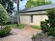 Exterior shot of a condo featuring a private back entrance and landscaped walkway at 3151 Landmark Dr # 115, Clearwater, FL 33761