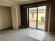 Bedroom with brown accent wall and sliding glass door to outdoor patio and closet at 3151 Landmark Dr # 115, Clearwater, FL 33761