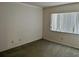 Bedroom with green carpet, off white and patterned walls, white trim and a large window at 3151 Landmark Dr # 115, Clearwater, FL 33761