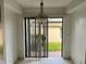 Dining room with white walls, tile floors, hanging light and view of brick patio at 3151 Landmark Dr # 115, Clearwater, FL 33761