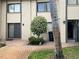 Exterior view of the condo building showcasing the courtyard and landscaping at 3151 Landmark Dr # 115, Clearwater, FL 33761