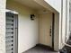Condo front door with a decorative light fixture and brick walkway at 3151 Landmark Dr # 115, Clearwater, FL 33761