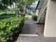 Charming condo exterior featuring well-maintained landscaping and a brick pathway at 3151 Landmark Dr # 115, Clearwater, FL 33761