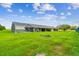 Spacious backyard featuring a screened pool, lanai, and lawn area at 34215 Kiefer Rd, Dade City, FL 33525