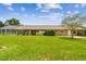 Expansive backyard featuring screened pool, open patio, and large lawn at 34215 Kiefer Rd, Dade City, FL 33525