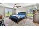 Comfortable bedroom featuring large windows and a bed with blue bedding at 34215 Kiefer Rd, Dade City, FL 33525