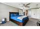 Cozy bedroom with a ceiling fan, neutral carpet, and a spacious bed at 34215 Kiefer Rd, Dade City, FL 33525