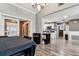Open-concept dining area features wood floors and a view into the kitchen at 34215 Kiefer Rd, Dade City, FL 33525