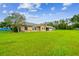 Charming single-story home featuring a well-manicured lawn and stone accents at 34215 Kiefer Rd, Dade City, FL 33525
