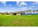 Spacious property featuring a screened-in pool and lush, expansive green lawn at 34215 Kiefer Rd, Dade City, FL 33525