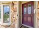 Charming home entrance with a stone pillar and decorative maroon front door at 34215 Kiefer Rd, Dade City, FL 33525