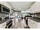 Modern kitchen with stainless steel appliances and an open view into the living room at 34215 Kiefer Rd, Dade City, FL 33525
