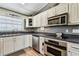 Stylish kitchen with stainless steel appliances, white cabinets, and neutral tones at 34215 Kiefer Rd, Dade City, FL 33525