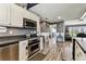 Spacious kitchen showcasing stainless steel appliances, white cabinetry, and wood-look floors at 34215 Kiefer Rd, Dade City, FL 33525
