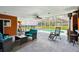 Screened lanai featuring ample seating area, ceiling fan, and views of pool, hot tub, and backyard at 34215 Kiefer Rd, Dade City, FL 33525