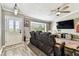 Bright living room featuring a bay window, ceiling fan, and cozy furniture at 34215 Kiefer Rd, Dade City, FL 33525