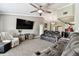 Comfortable living room with a large TV, plush seating, and carpeted floor at 34215 Kiefer Rd, Dade City, FL 33525
