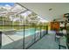 Screened pool area featuring swimming pool, hot tub, outdoor seating, and access to the lanai at 34215 Kiefer Rd, Dade City, FL 33525