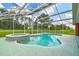 Backyard swimming pool and attached hot tub within screened enclosure and lawn at 34215 Kiefer Rd, Dade City, FL 33525