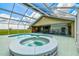In-ground pool and hot tub are enclosed by a screened enclosure, perfect for outdoor living at 34215 Kiefer Rd, Dade City, FL 33525
